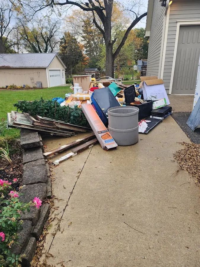 Dumpster being loaded with debris for Roofing Dumpster Rental in Missouri City